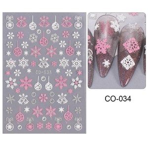 Detail view of pink and white Christmas nail stickers with snowflakes and bells patterns