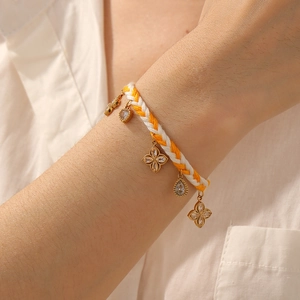 Handmade woven chain bracelet with gold-plated flower pendants and sparkling crystals