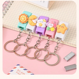 Mini cartoon stapler keychains in sun moon cloud star shapes on a notebook edge