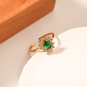 Adjustable gold stainless steel ring featuring emerald green zircon in sunflower setting