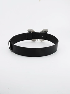 Detail view of black leather belt with a large silver metal butterfly buckle on white background