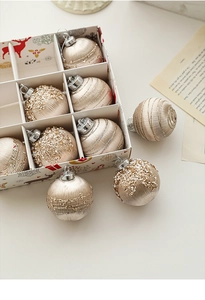 Detail of champagne gold Christmas balls with glitter threads in a decorative gift box