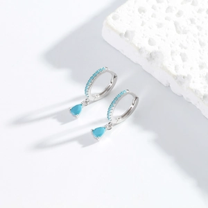 Detailed macro view of S925 silver fan drop earrings with sky blue crystal and diamonds