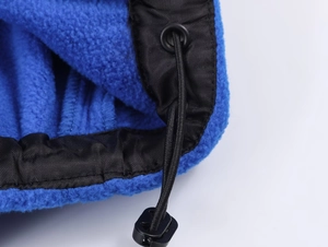 Detail shot of blue fleece fabric texture with black drawstring and adjustable plastic toggle