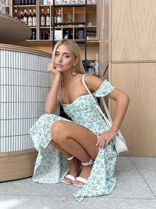 Detail of floral print pattern on off-shoulder summer dress with side slit design