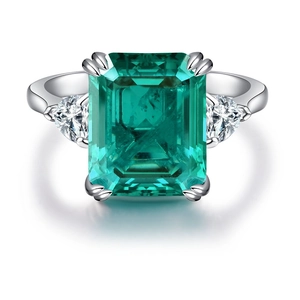 S925 sterling silver emerald cut ring with triangular diamond side stones on white background