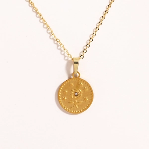 Close-up of golden rose pendant with small diamond inlay and beaded edge detail