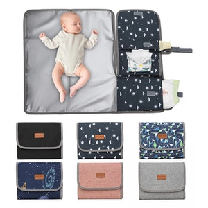 Macro detail of foldable waterproof diaper changing mat in multiple colors and patterns