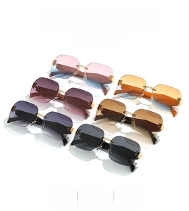 Detail view of various rimless sunglasses with gradient lenses and metal temples