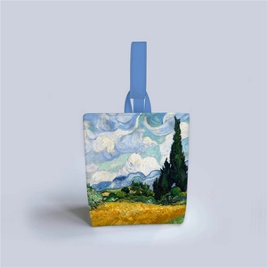 Detail view of canvas tote featuring Van Gogh's Wheat Field with Cypresses and blue handles