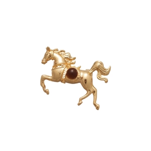 Vintage gold plated horse brooch with deep red resin bead in a running posture