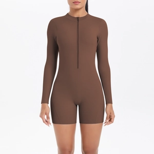Women's dark brown long sleeve yoga jumpsuit with a half-zip front and peach lift fit