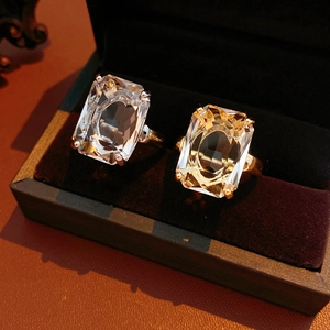 Detailed close-up of 14k gold plated square zircon rings in a luxury leather jewelry box