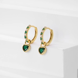 Detailed view of gold heart drop earrings featuring green and white cubic zirconia stones