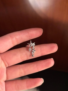 Macro shot of sparkling star-shaped ring with cubic zirconia on a model's hand