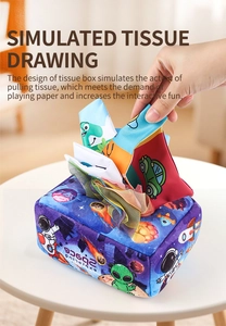 Space-themed baby tissue box toy being used to show sensory cloth pulling action