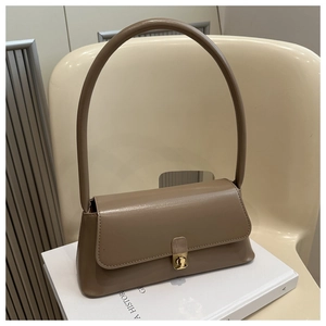 Detailed close-up of khaki PU leather baguette bag with elegant golden clasp detail