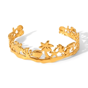 Detail of gold-plated stainless steel cuff featuring sea turtle and palm tree motifs