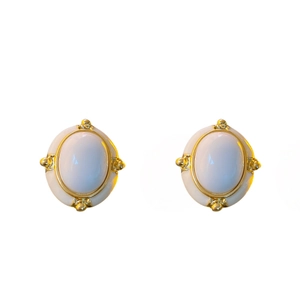 Vintage oval studs with white stones and gold accents on a plain white background