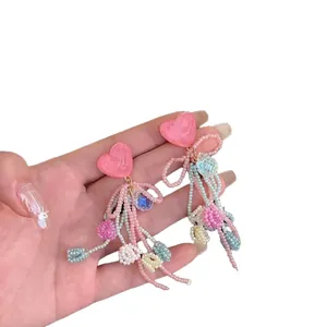 Pink heart pearl tassel earrings with handmade beaded bows and dangling fringe