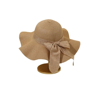 Elegant khaki wide-brim straw sun hat with wavy edge and stylish ribbon bow detail