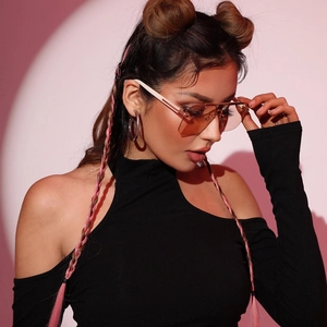 Fashion rimless oversized sunglasses with brown tinted lenses worn by a model in a studio