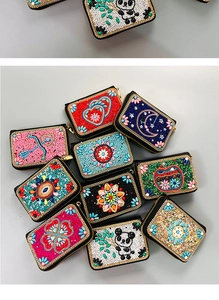 Detail of bohemian handmade beaded card holders with 3D embroidery and panda patterns