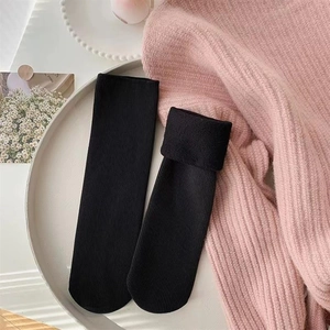 Close-up of black ribbed thermal socks showing thick fleece lining and knit texture