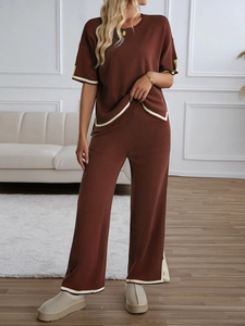 Detail of a brown knit loungewear set featuring beige and navy color-block piping on the edges