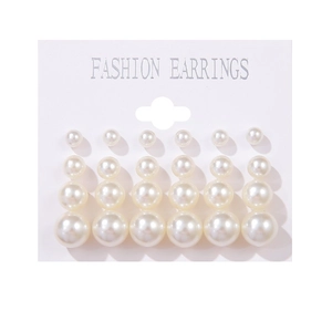 Detailed view of six pairs of white imitation pearl earrings in various sizes on display card