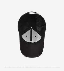 Detailed interior of black baseball cap showing white lining, seams, and adjustable buckle