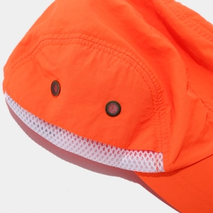 Detail of high-visibility orange sun hat with white mesh and metal ventilation eyelets