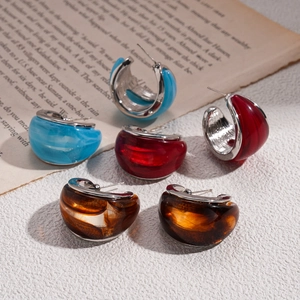 Resin C-shaped hoop earrings with metal trim on vintage book pages for a retro aesthetic