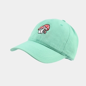 Detailed embroidery of three mushrooms on a mint green cotton baseball cap texture