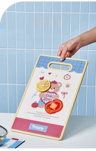 Detail view of the standing PE cutting board with a cute bear print and handle