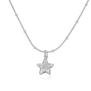 Detailed macro of a silver star pendant with hammered texture and cubic zirconia stones