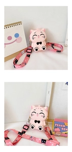 Detailed close-up of pink cat-shaped silicone crossbody bag with patterned shoulder strap