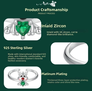 Macro detail of 925 sterling silver Christmas reindeer ring with green heart zircon