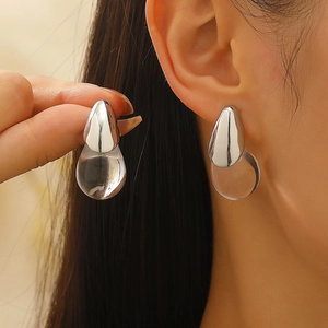 Minimalist silver teardrop earrings with clear resin drop detail for a modern jewelry look