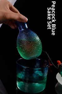 Close-up of peacock blue sake set featuring hammered glass texture and gradient finish