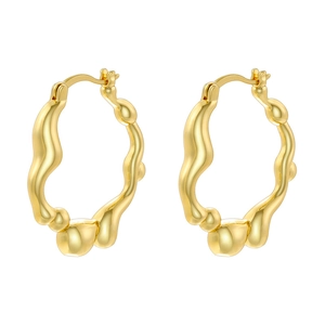 Detail view of irregular golden hoop earrings with wavy texture and metallic finish