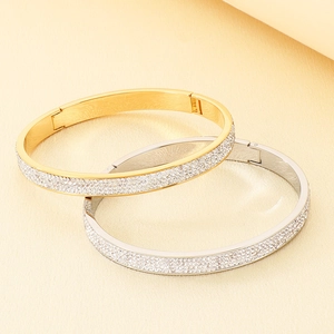 Détails des bracelets entrelacés en or et argent sertis de cristaux étincelants en pavé