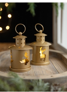 Close-up of golden vintage Christmas lanterns with reindeer and tree cutout patterns