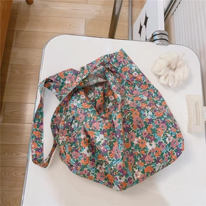 Detail of floral cotton tote bag with soft fabric texture and vintage flower patterns