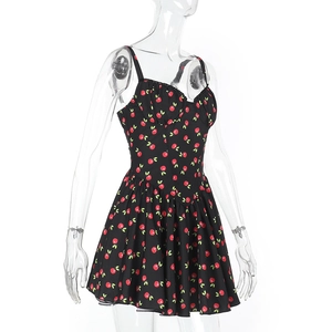 Detail of sweetheart neckline and cherry print on black summer mini dress with thin straps