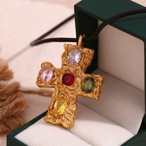 Detail of 18K gold-plated cross pendant with five colorful gemstones and black rope chain