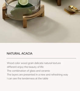 Detail of acacia wood base and smoky gray glass bowl for home decor and dining