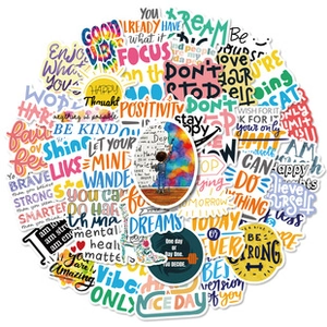 Flat lay of colorful vinyl inspirational quote stickers for DIY laptop and suitcase decor