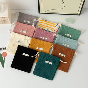 Large capacity corduroy drawstring storage pouches in various colors on a white surface
