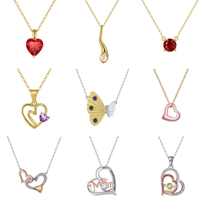 Detail of nine Bohemian pendants featuring colorful natural stones and heartfelt engravings